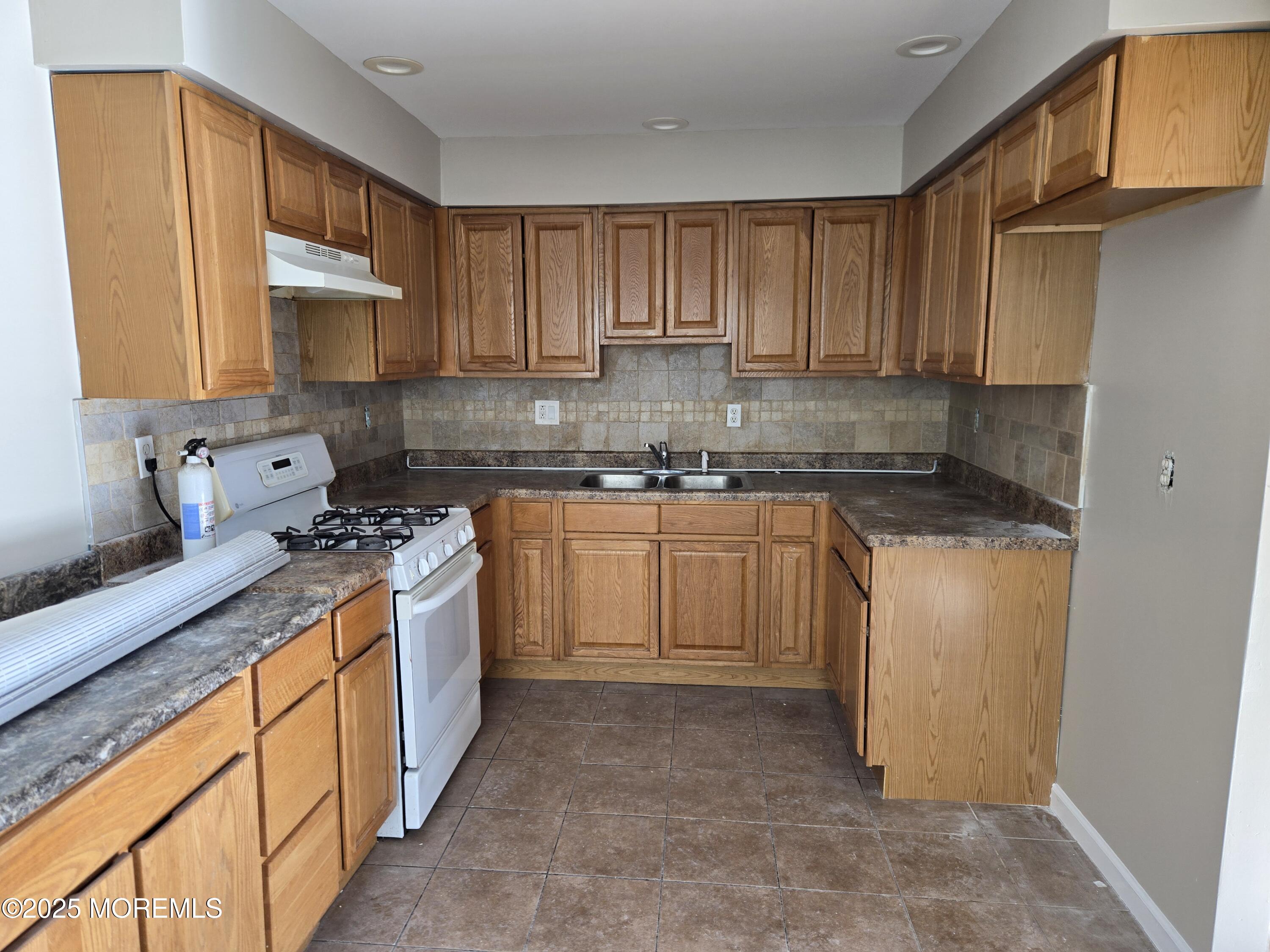 121 Governors Road Lakewood, NJ 08701 - Photo 3 of 7 a kitchen with a sink stove and cabinets