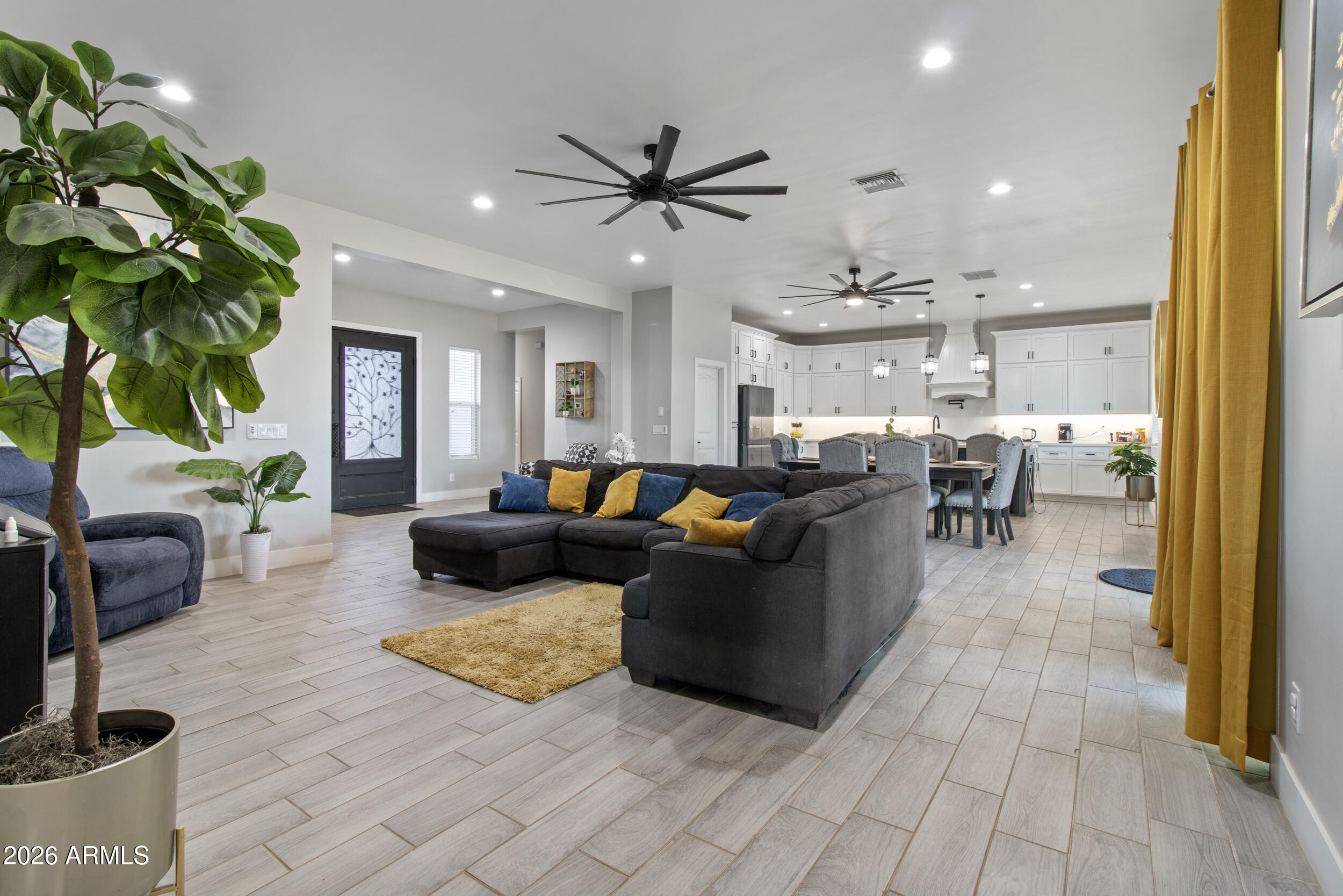 22531 West Harwell Road Buckeye, AZ 85326 - Photo 12 of 40 a living room with furniture kitchen view and a chandelier