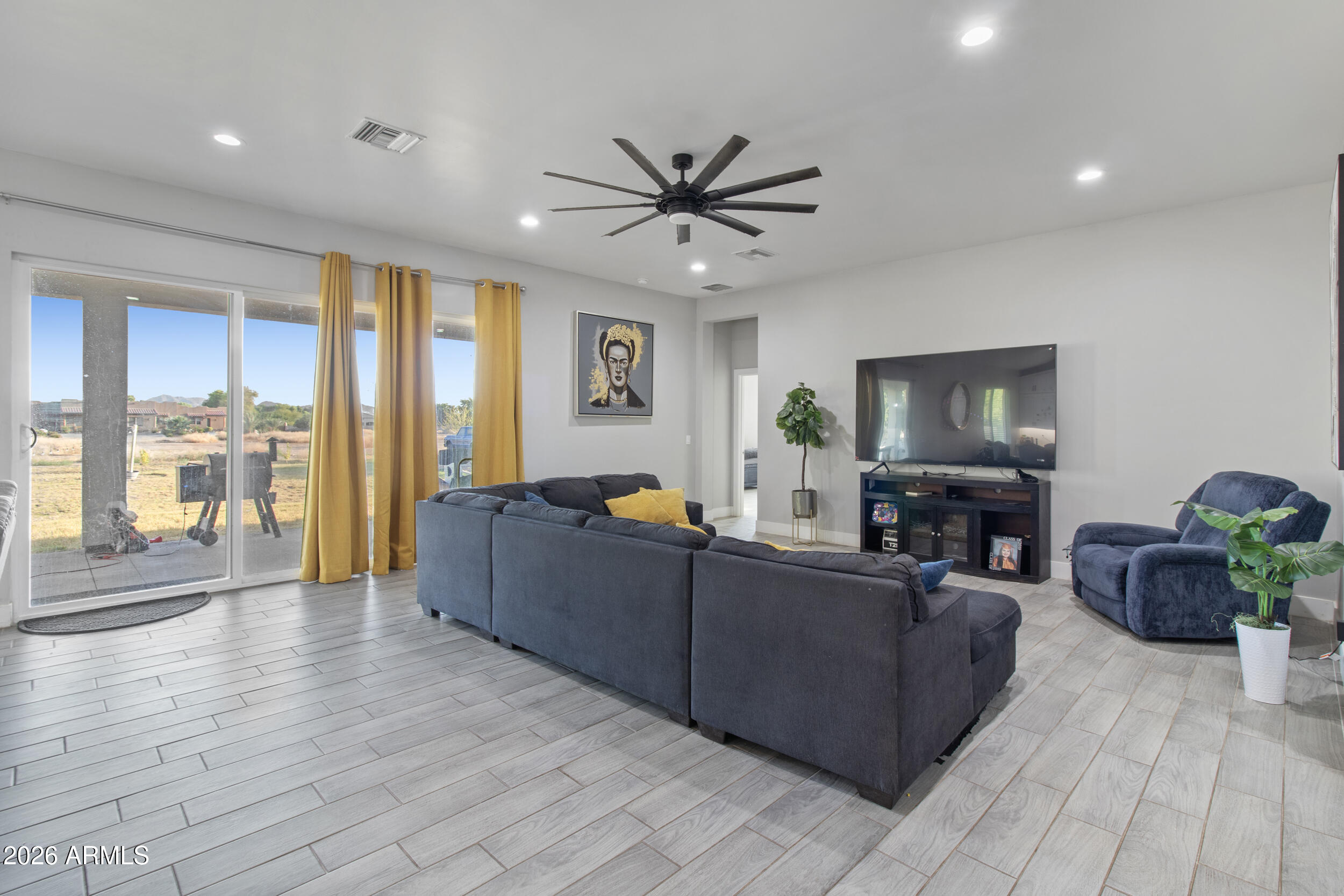 22531 West Harwell Road Buckeye, AZ 85326 - Photo 13 of 40 a living room with furniture and a flat screen tv
