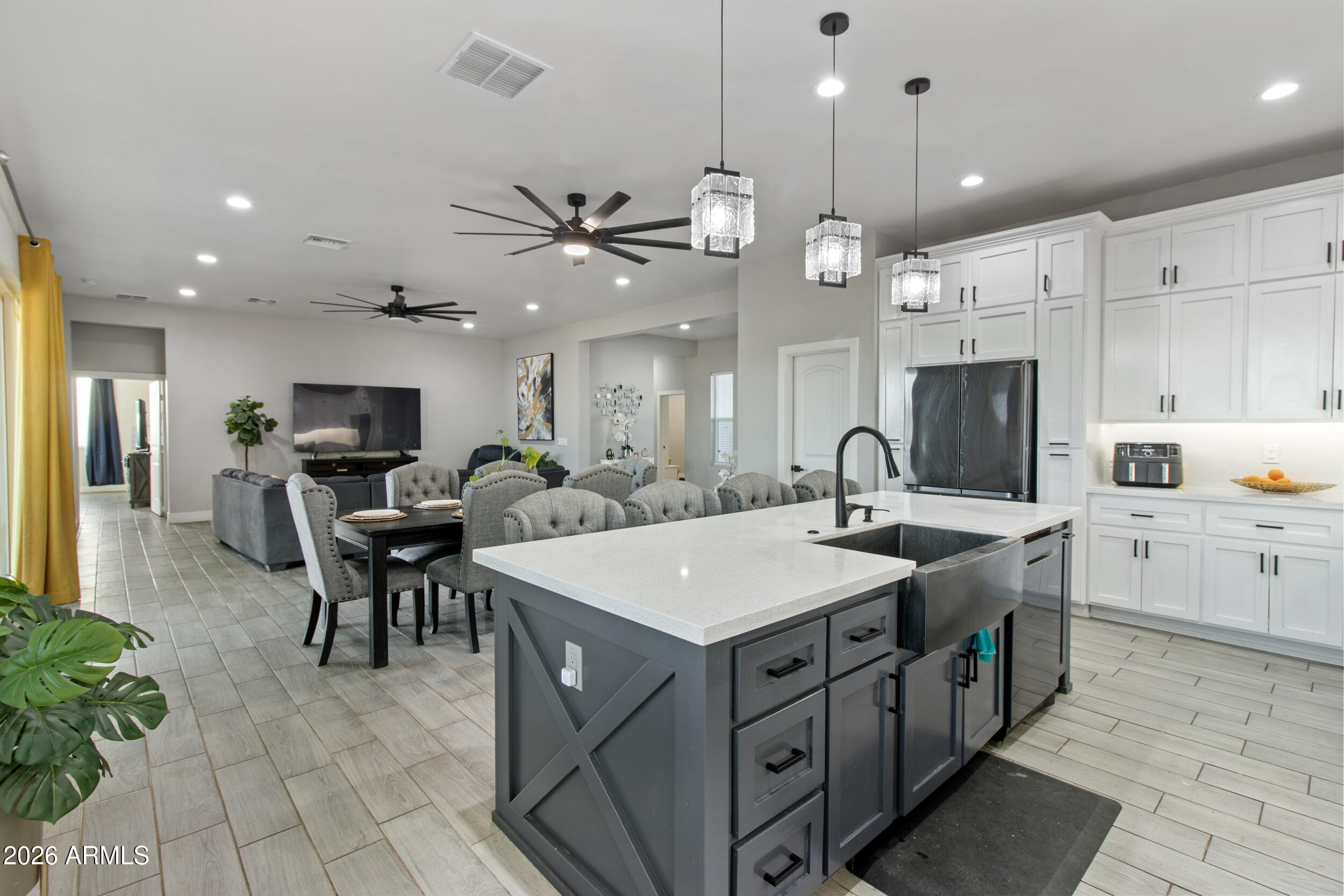22531 West Harwell Road Buckeye, AZ 85326 - Photo 17 of 40 a large kitchen with kitchen island a sink table and chairs