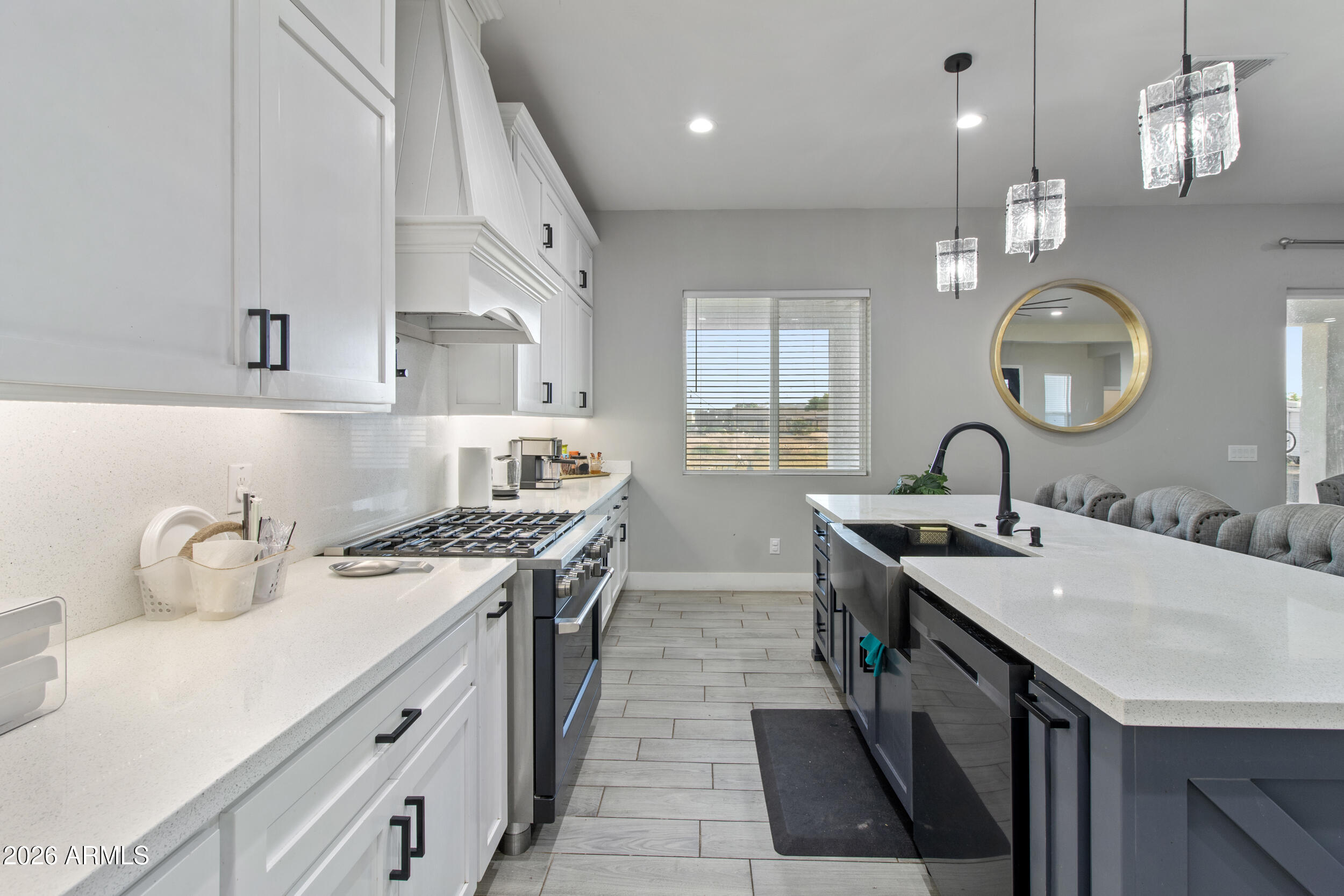 22531 West Harwell Road Buckeye, AZ 85326 - Photo 18 of 40 a kitchen with a sink a stove and cabinets