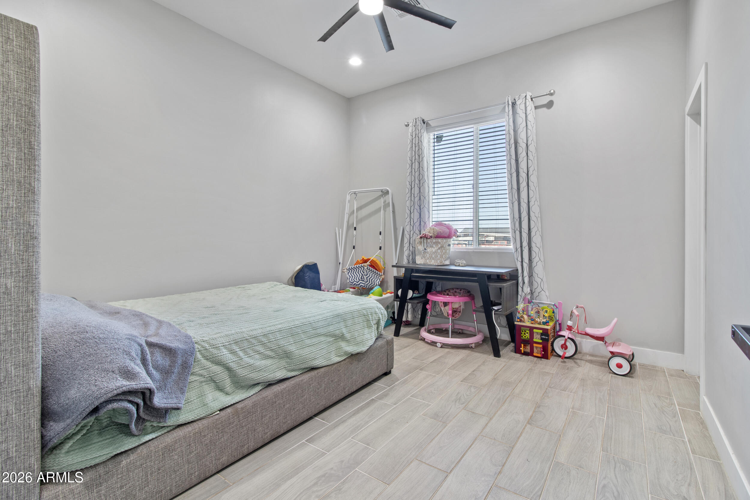 22531 West Harwell Road Buckeye, AZ 85326 - Photo 25 of 40 a bedroom with a bed and a chandelier