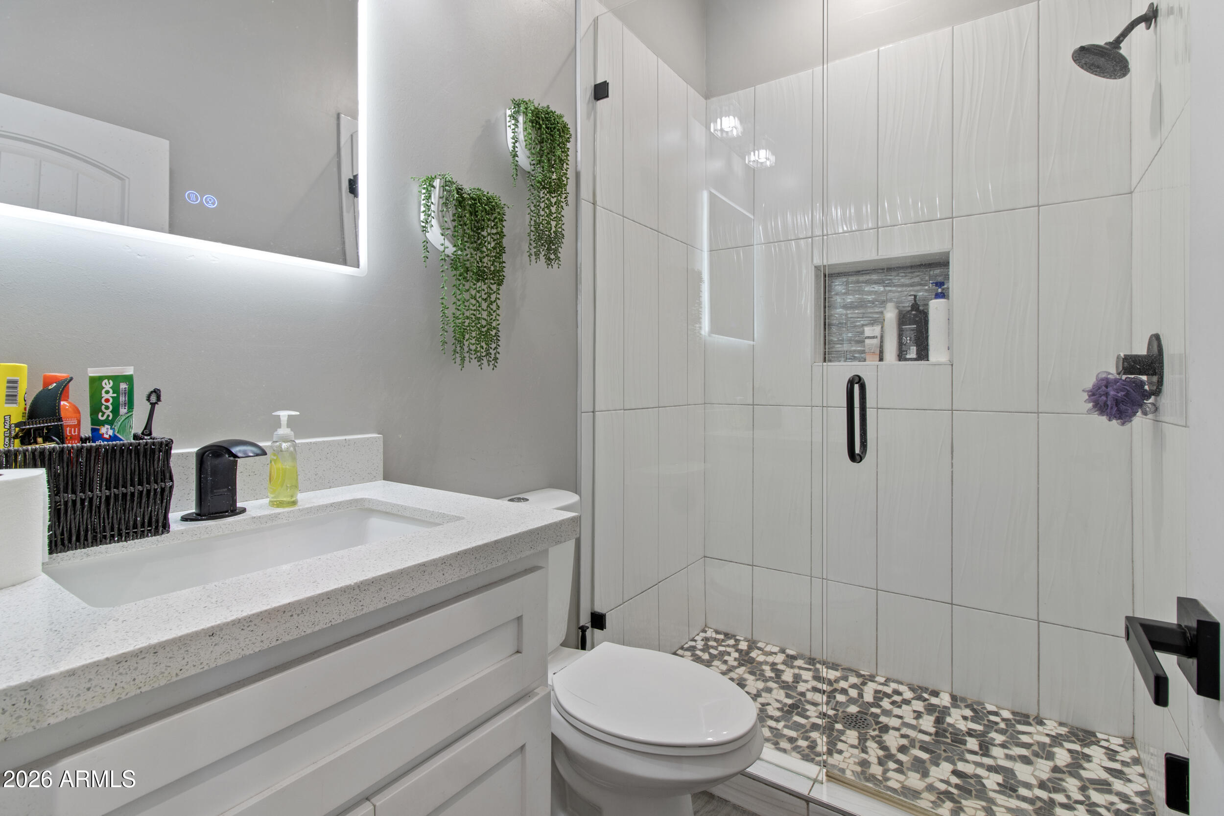 22531 West Harwell Road Buckeye, AZ 85326 - Photo 26 of 40 a bathroom with a sink a toilet and shower