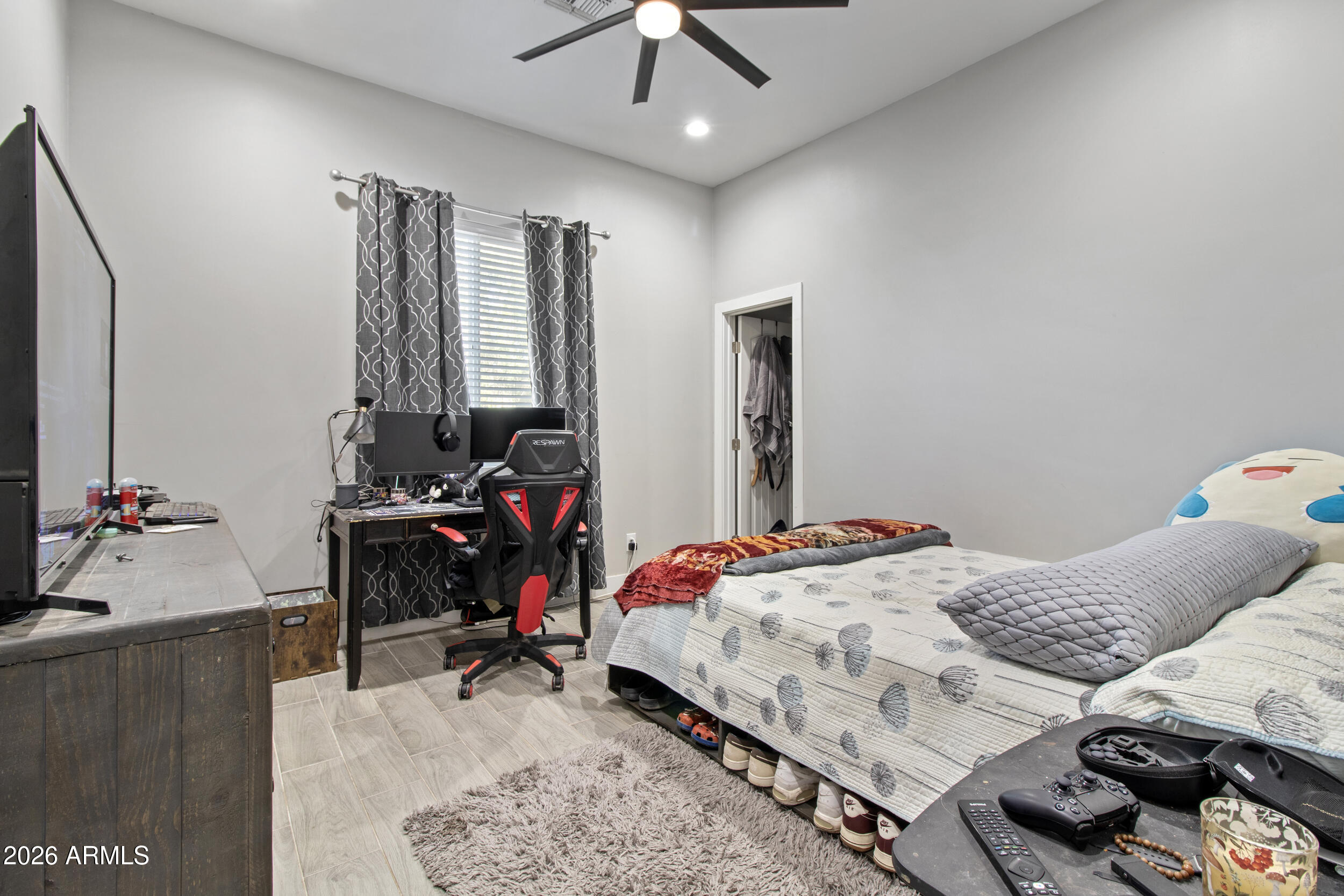 22531 West Harwell Road Buckeye, AZ 85326 - Photo 27 of 40 a bed room with a bed and a chandelier