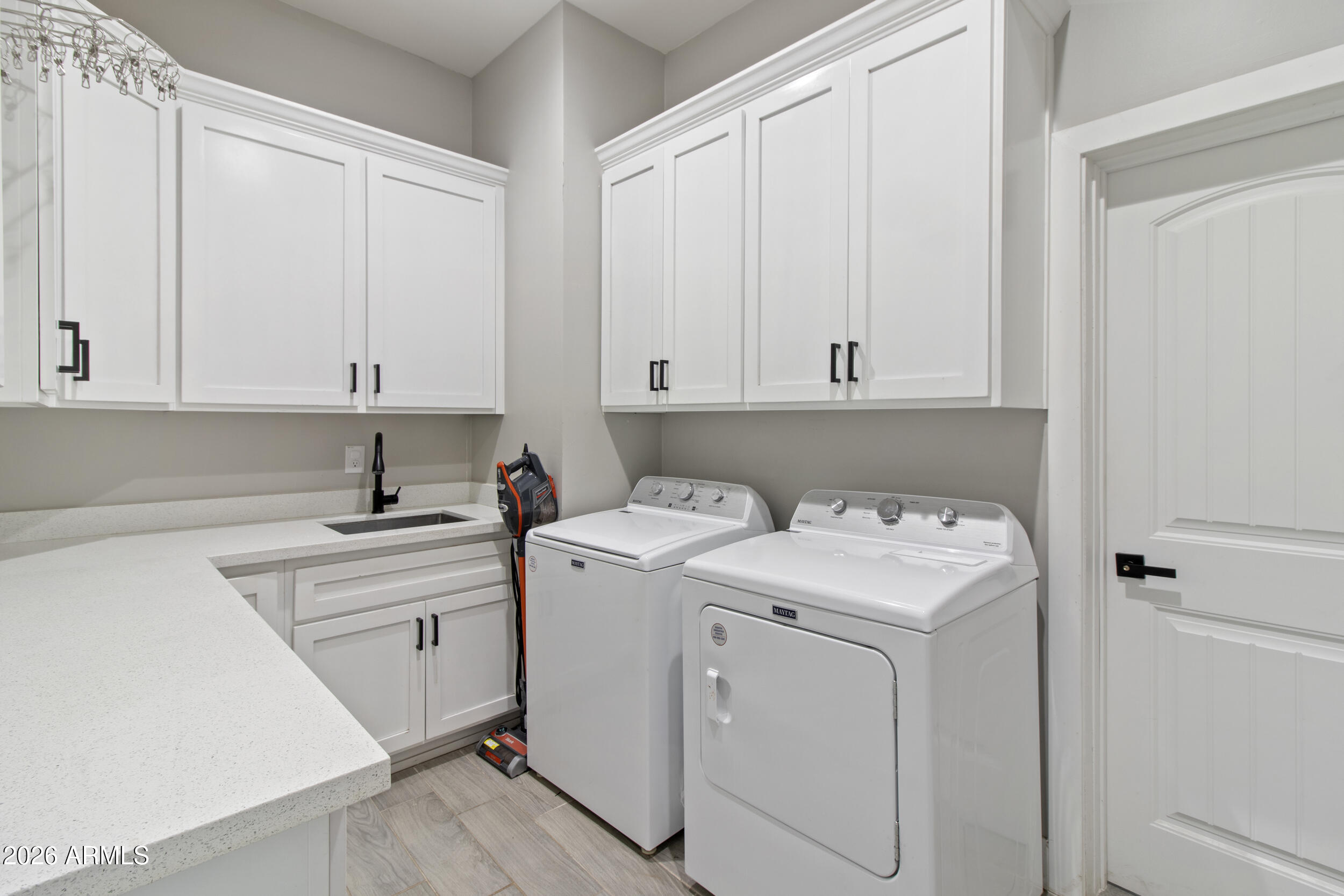 22531 West Harwell Road Buckeye, AZ 85326 - Photo 29 of 40 a view of a storage and utility room with washer and dryer