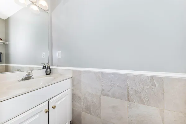 a roof deck with a barbeque and wooden stairs
