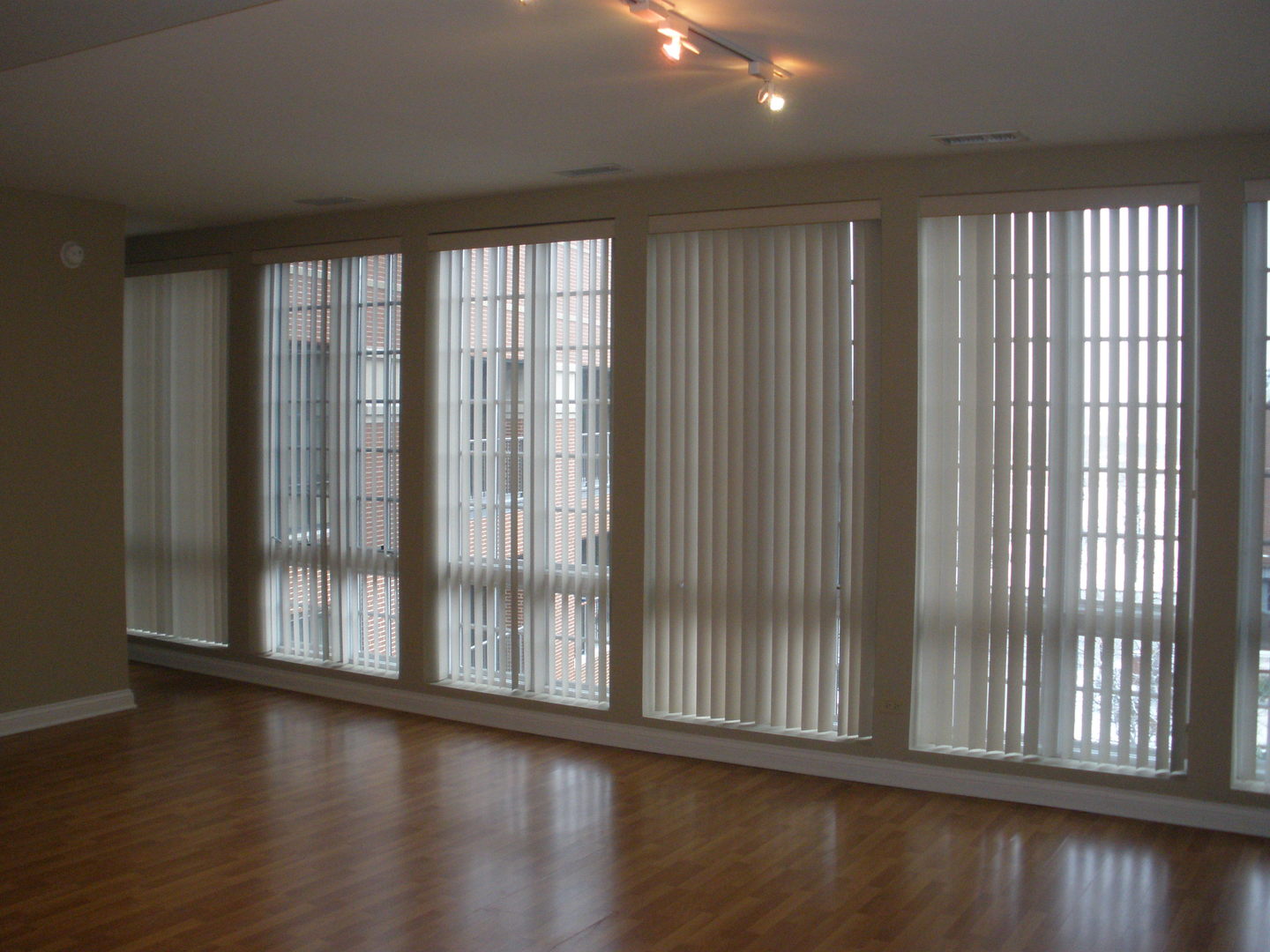 1801 Tower Drive, Unit E243 Glenview, IL 60026 - Photo 11 of 26 a view of an empty room with wooden floor and a window