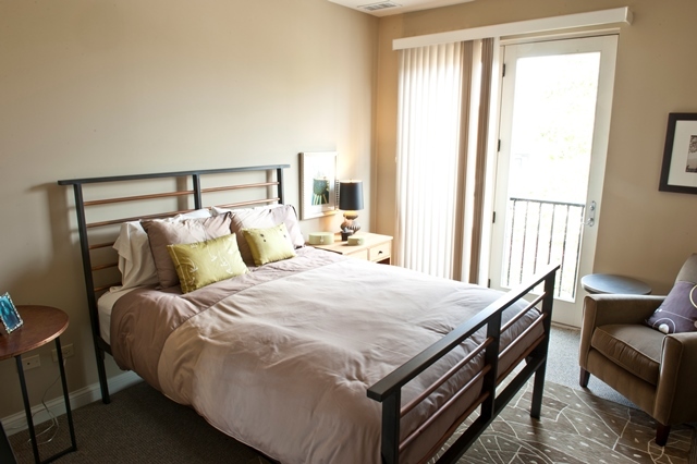 1801 Tower Drive, Unit E243 Glenview, IL 60026 - Photo 12 of 26 a bedroom with a bed and a window