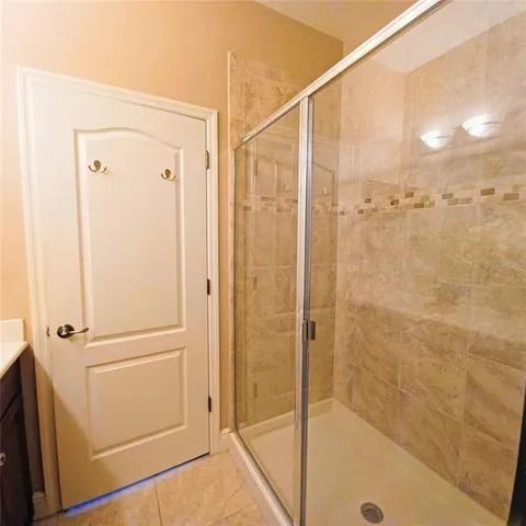 a bathroom with a shower and a glass door