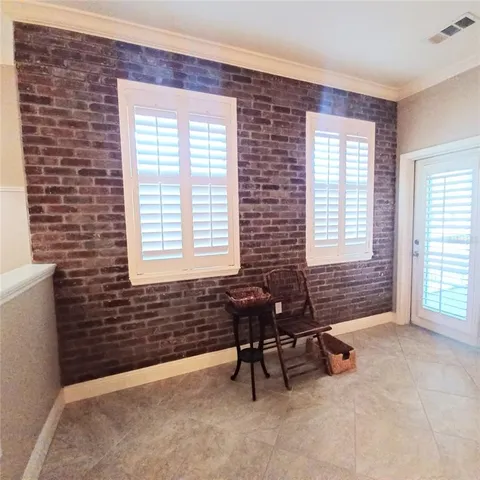a view of a livingroom with a chair and a window