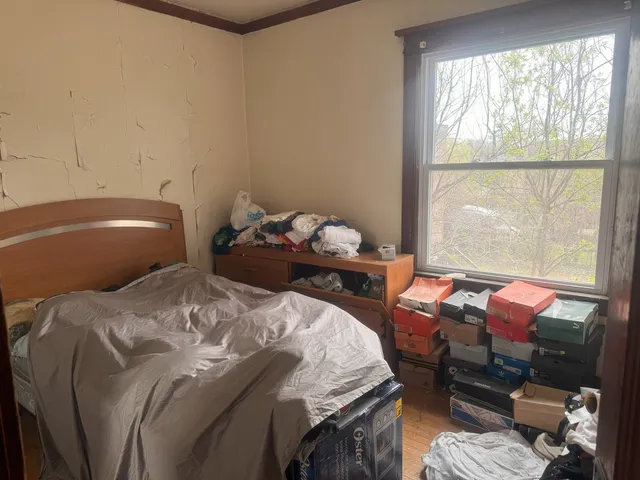 a bedroom with a bed and a window