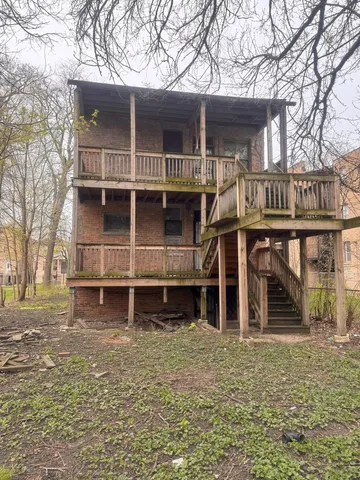 front view of a house with a large tree