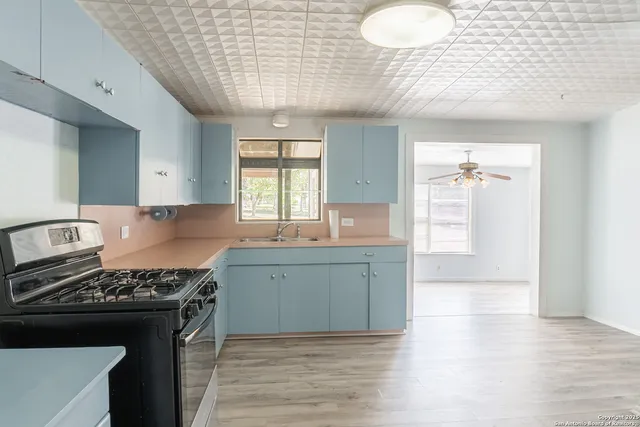 a kitchen with a stove and a wooden floors