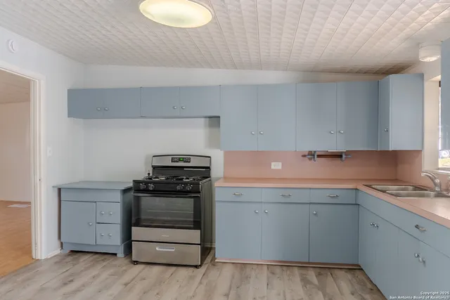 a kitchen with a stove and a sink