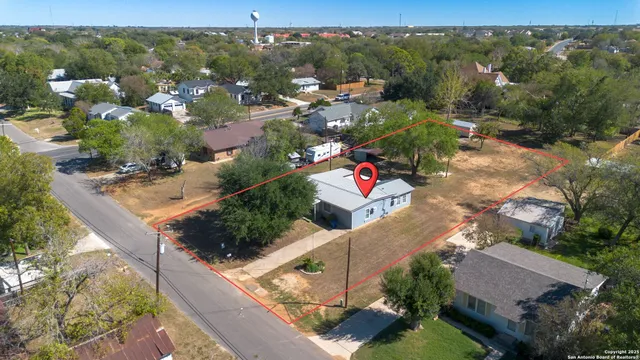 an aerial view of a house with a yard