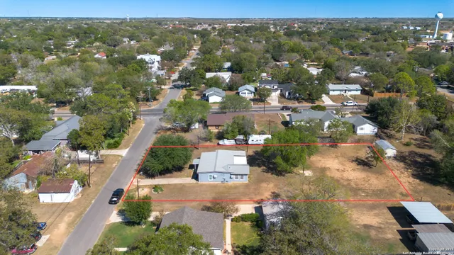 an aerial view of residential houses with outdoor space and street view
