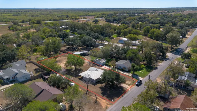 an aerial view of multiple houses with yard