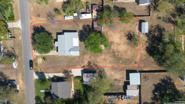 an aerial view of a house with outdoor space
