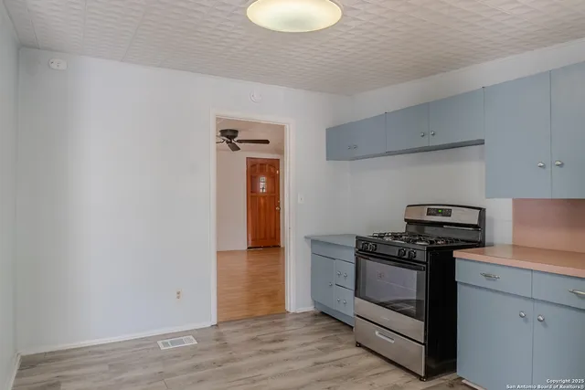 a kitchen with a stove and a refrigerator