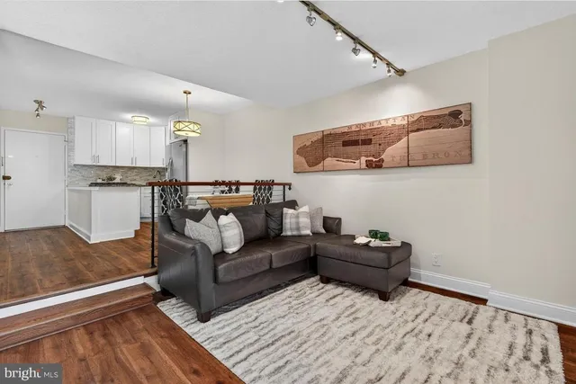 a living room with furniture and wooden floor