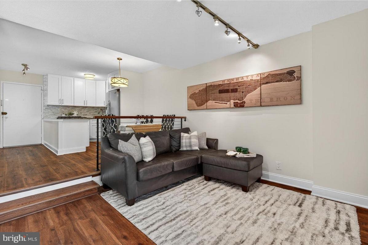 2201 L Street Northwest, Unit 316 Washington, DC 20037 - Photo 11 of 20 a living room with furniture and wooden floor