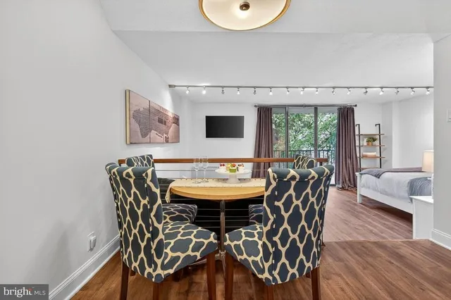 a view of a dining room with furniture and wooden floor