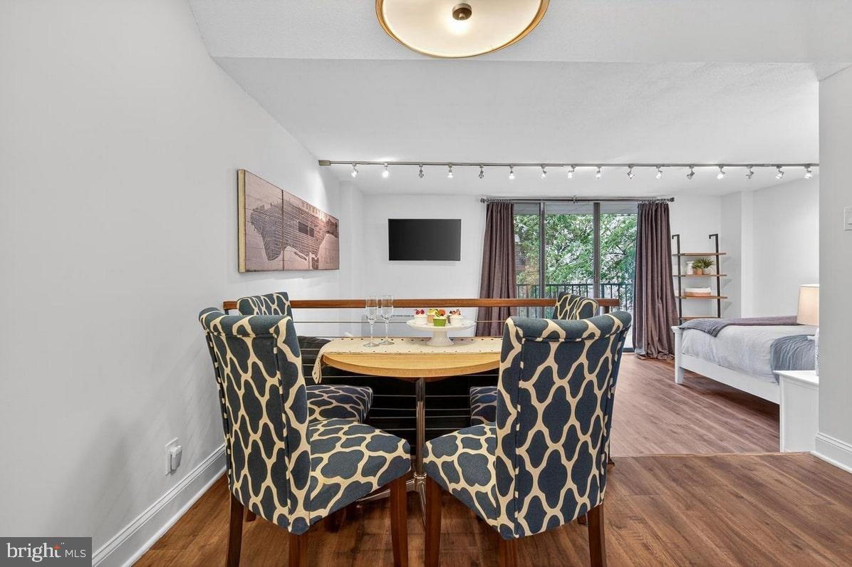 2201 L Street Northwest, Unit 316 Washington, DC 20037 - Photo 12 of 20 a view of a dining room with furniture and wooden floor