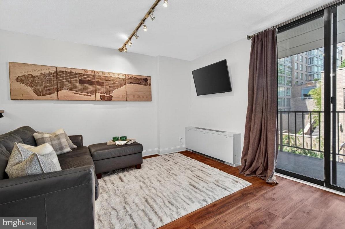 2201 L Street Northwest, Unit 316 Washington, DC 20037 - Photo 5 of 20 a living room with furniture and a flat screen tv