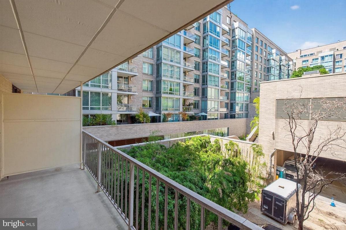 2201 L Street Northwest, Unit 316 Washington, DC 20037 - Photo 7 of 20 a balcony view with tall trees
