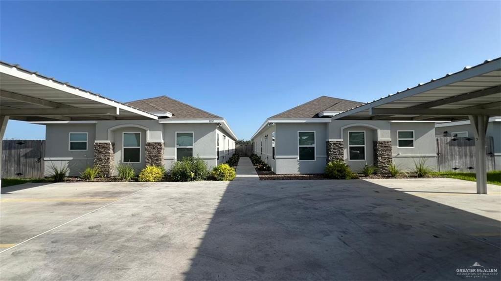 2112 Redbud Lane Weslaco, TX 78596 - Photo 1 of 7 a front view of a house with a garden