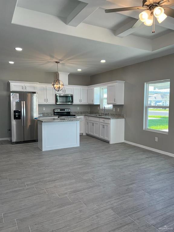 2112 Redbud Lane Weslaco, TX 78596 - Photo 2 of 7 a large kitchen with stainless steel appliances granite countertop a stove and a sink