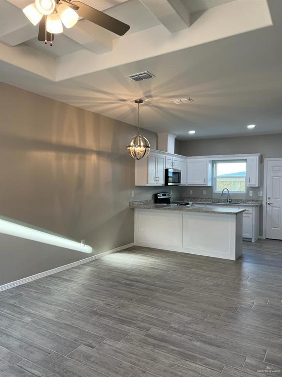 2112 Redbud Lane Weslaco, TX 78596 - Photo 3 of 7 a view of kitchen with refrigerator microwave and stove