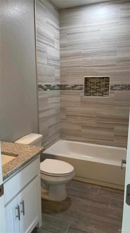 2112 Redbud Lane Weslaco, TX 78596 - Photo 5 of 7 a bathroom with a granite countertop toilet and a shower