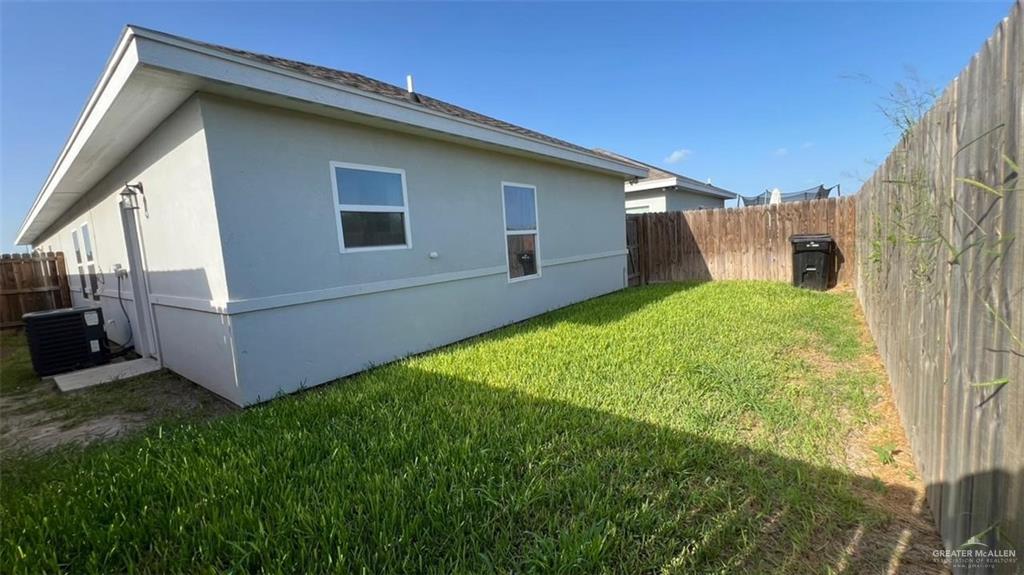 2112 Redbud Lane Weslaco, TX 78596 - Photo 6 of 7 a view of backyard with barbeque grill and wooden fence