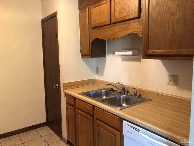 a kitchen with a stove top oven and cabinets