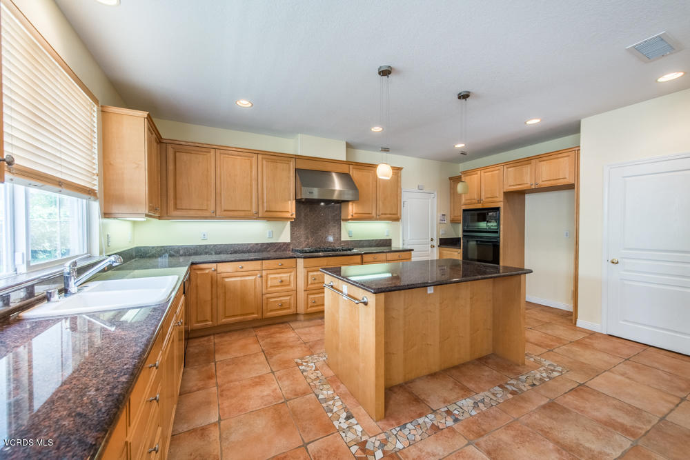 277 Knoll Ridge Road Simi Valley, CA 93065 - Photo 16 of 37 a kitchen with stainless steel appliances granite countertop a sink a stove and a refrigerator