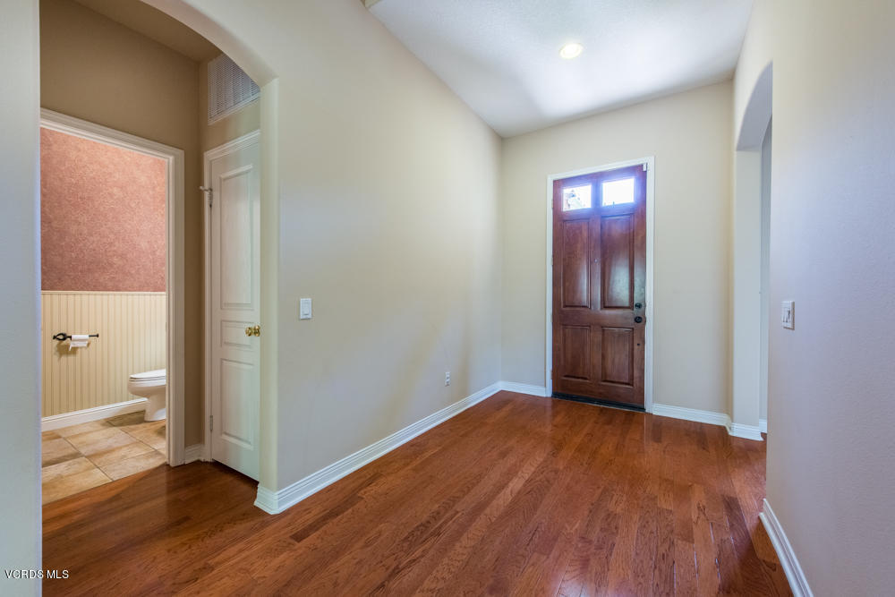 277 Knoll Ridge Road Simi Valley, CA 93065 - Photo 6 of 37 an empty room with wooden floor and windows