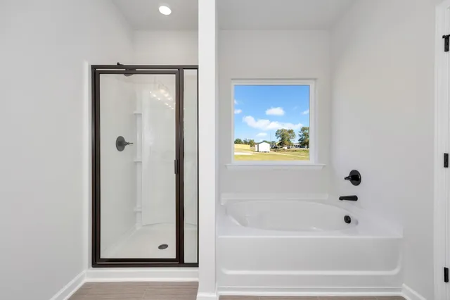 a bathroom with bathtub and shower