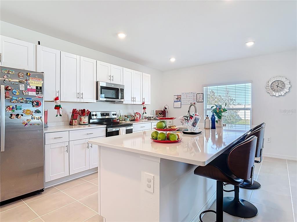 1146 Calico Pointe Circle Groveland, FL 34736 - Photo 12 of 54 a kitchen with a sink appliances cabinets and a counter top space
