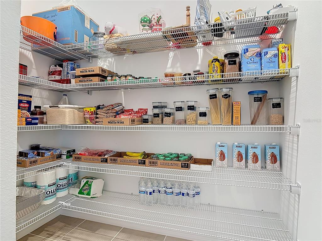 1146 Calico Pointe Circle Groveland, FL 34736 - Photo 20 of 54 a cabinet with granite countertop lots of different kinds of food