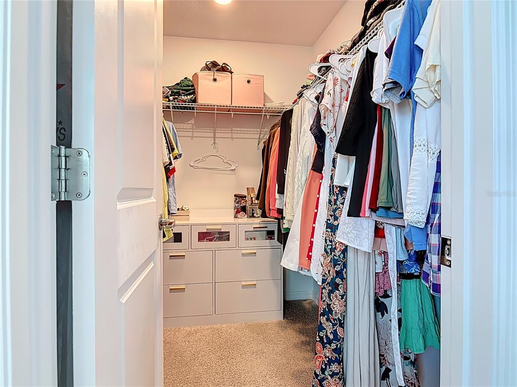 1146 Calico Pointe Circle Groveland, FL 34736 - Photo 27 of 54 a view of walk in closet with clothes and shoes