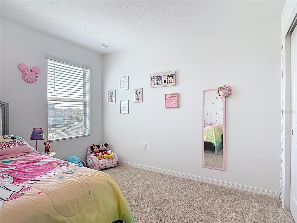 1146 Calico Pointe Circle Groveland, FL 34736 - Photo 33 of 54 a bedroom with a bed and a window