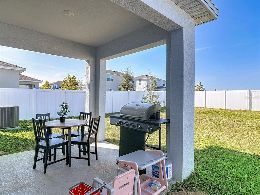 1146 Calico Pointe Circle Groveland, FL 34736 - Photo 40 of 54 a dining room with furniture and garden view