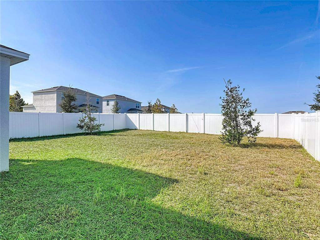 1146 Calico Pointe Circle Groveland, FL 34736 - Photo 46 of 54 a view of a house with a garden