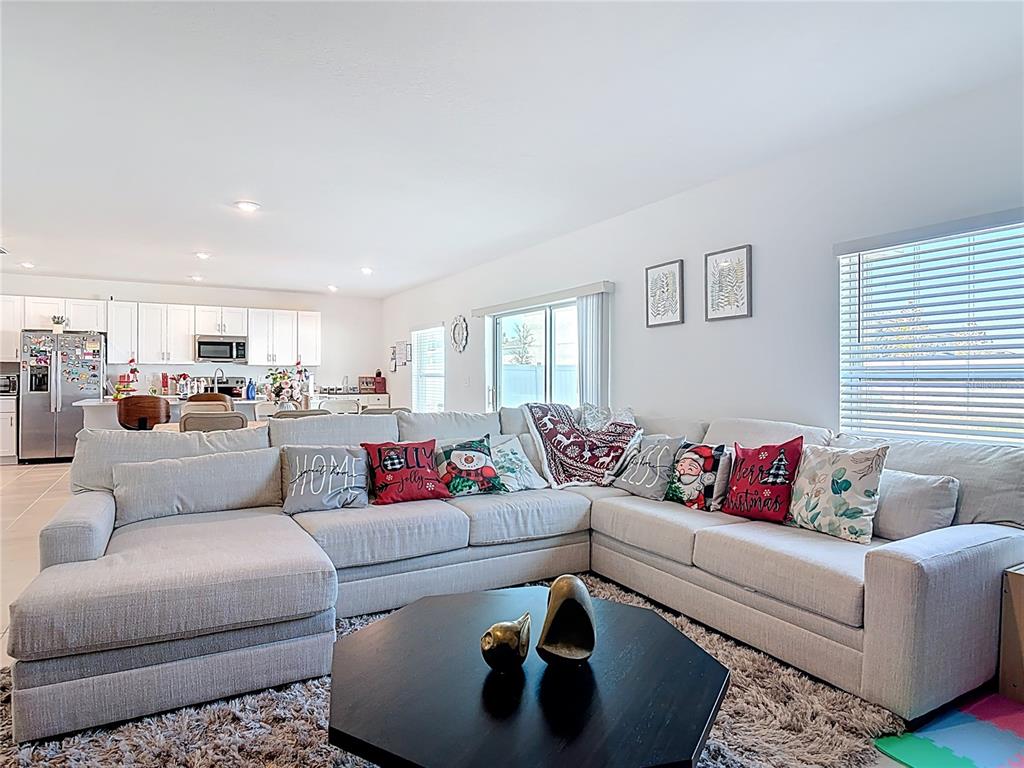1146 Calico Pointe Circle Groveland, FL 34736 - Photo 6 of 54 a living room with furniture and a view of kitchen