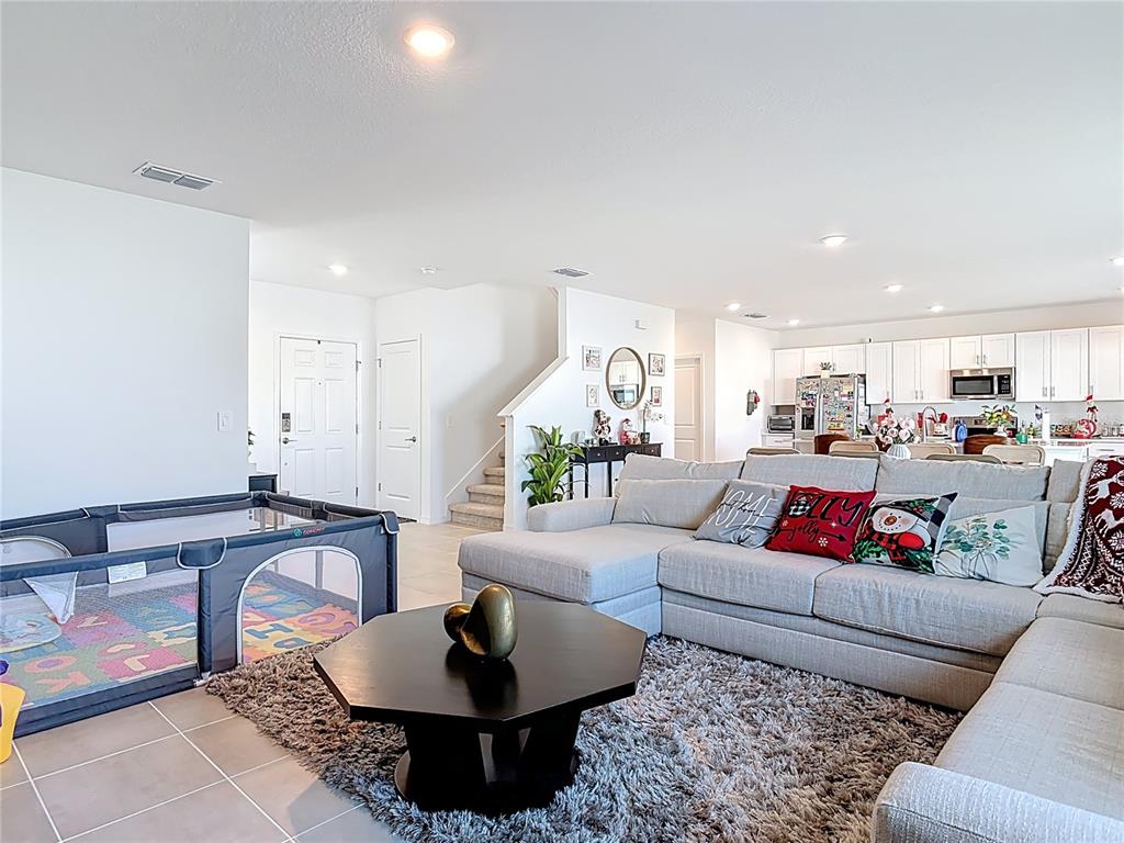 1146 Calico Pointe Circle Groveland, FL 34736 - Photo 7 of 54 a living room with furniture and a view of kitchen