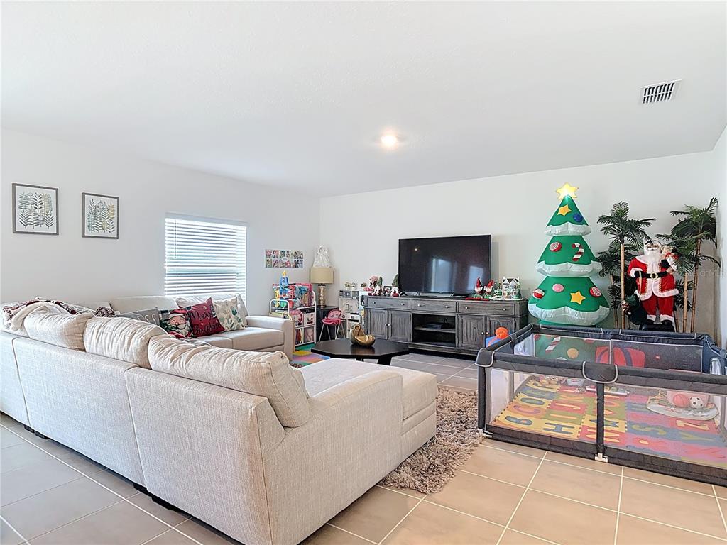 1146 Calico Pointe Circle Groveland, FL 34736 - Photo 8 of 54 a living room with furniture and a flat screen tv