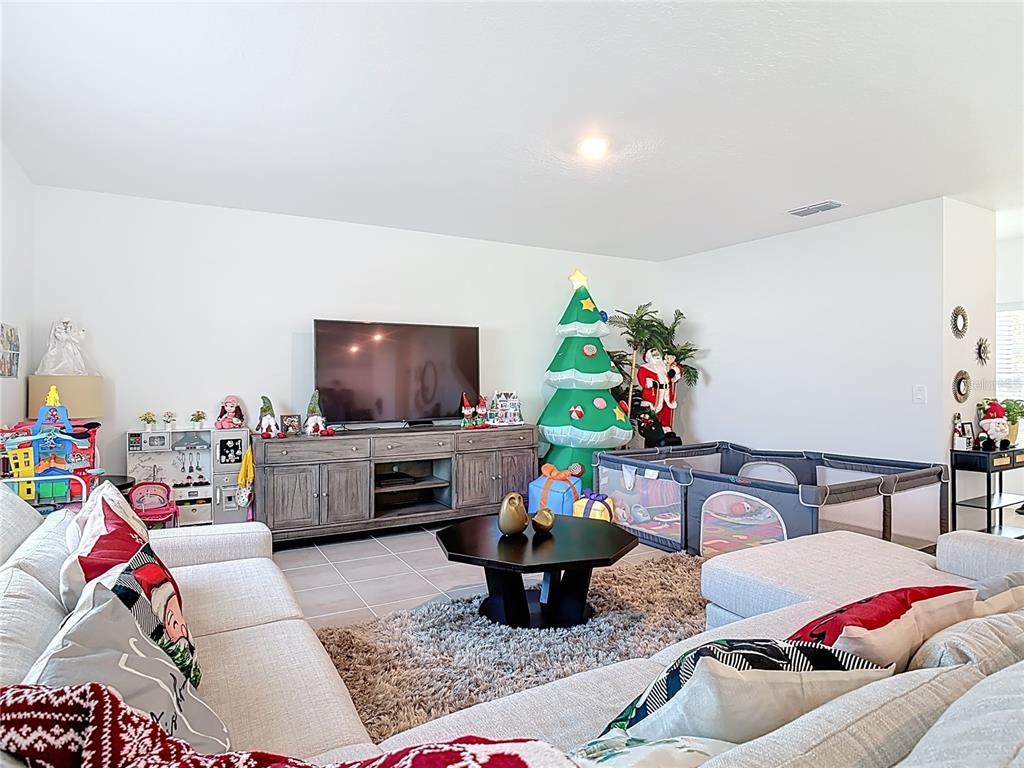 1146 Calico Pointe Circle Groveland, FL 34736 - Photo 9 of 54 a living room with furniture and a flat screen tv