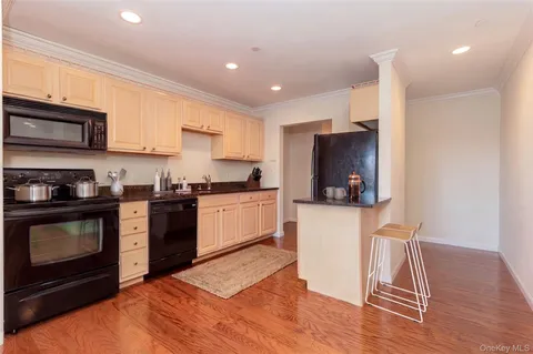 a kitchen with a sink a microwave and cabinets