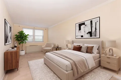 a bedroom with bed and a potted plant